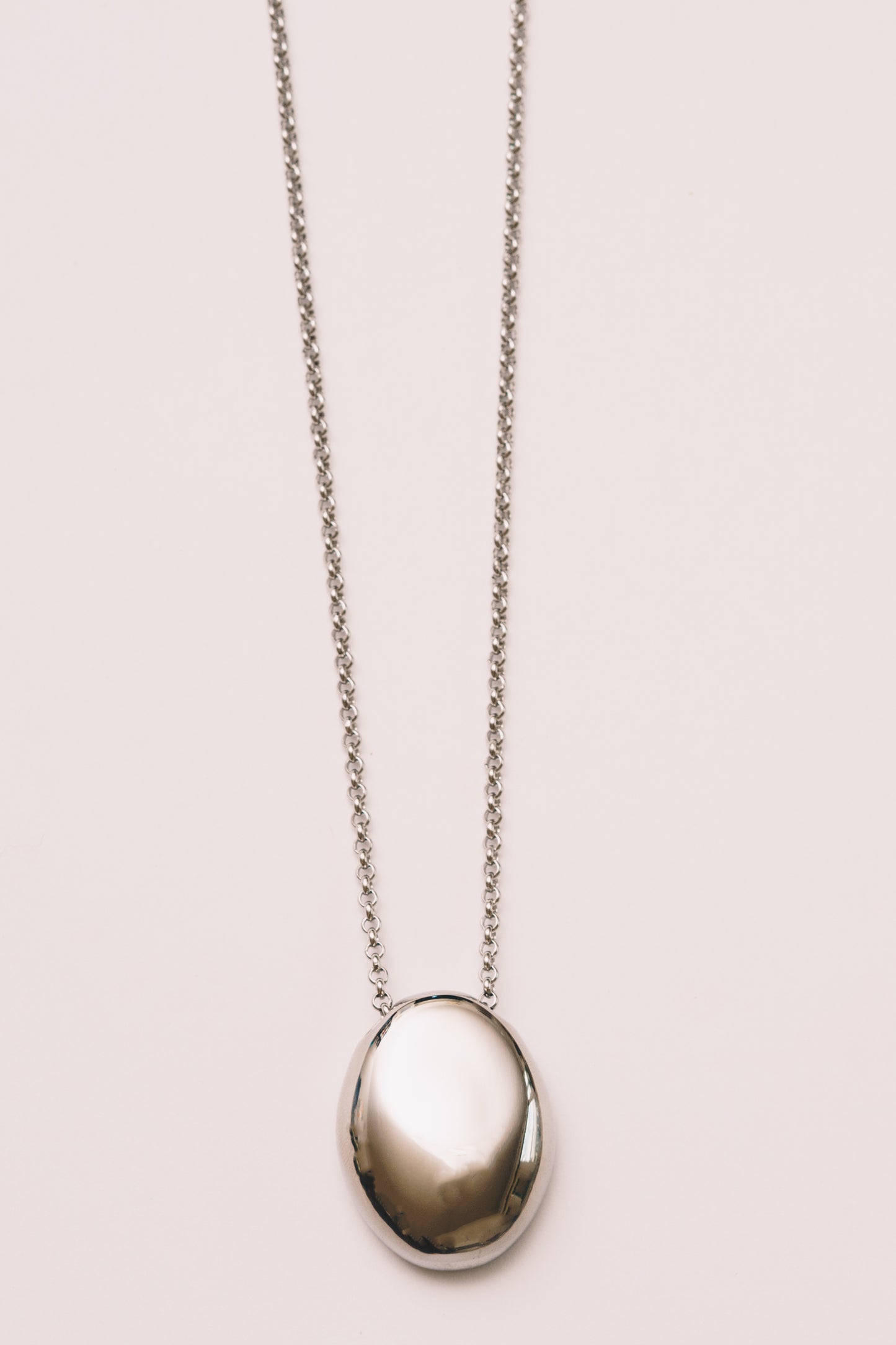 minimal necklace in silver pendant layering necklace in shiny finish on white background