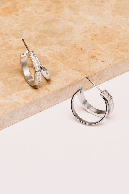 split hoop crystal earrings on marble brown and white background